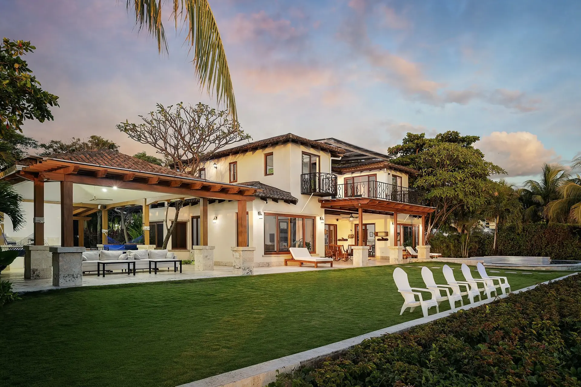 Casa Colorados illuminated at twilight beside the Pacific