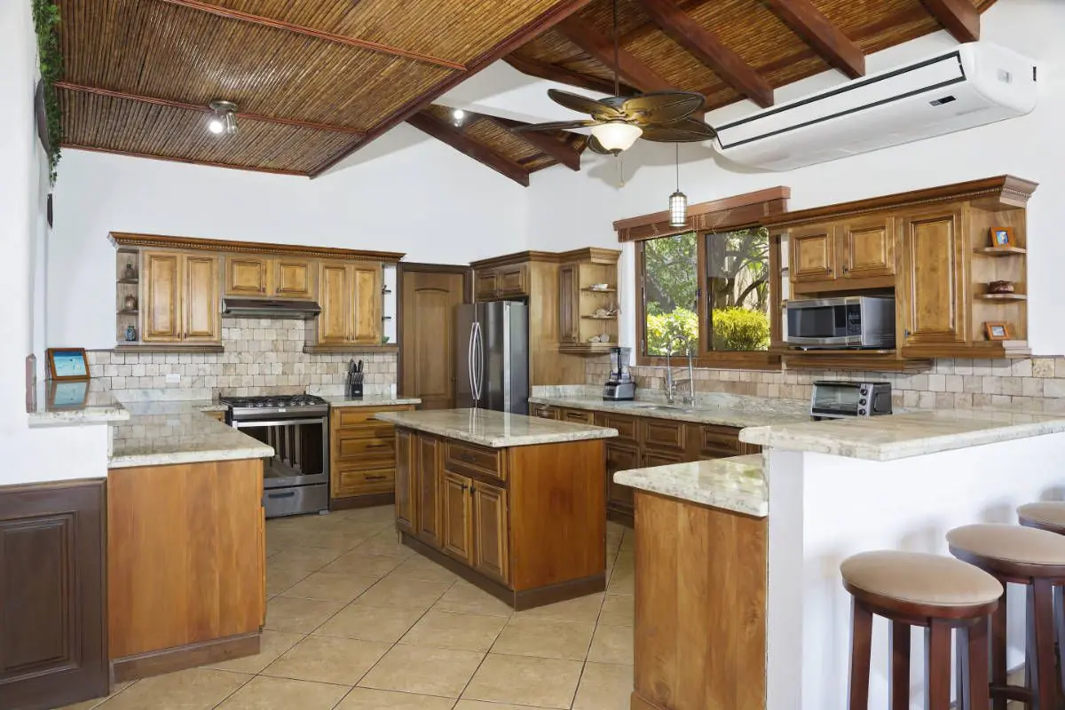 Casa Colorados kitchen with wood cabinetry and granite counters