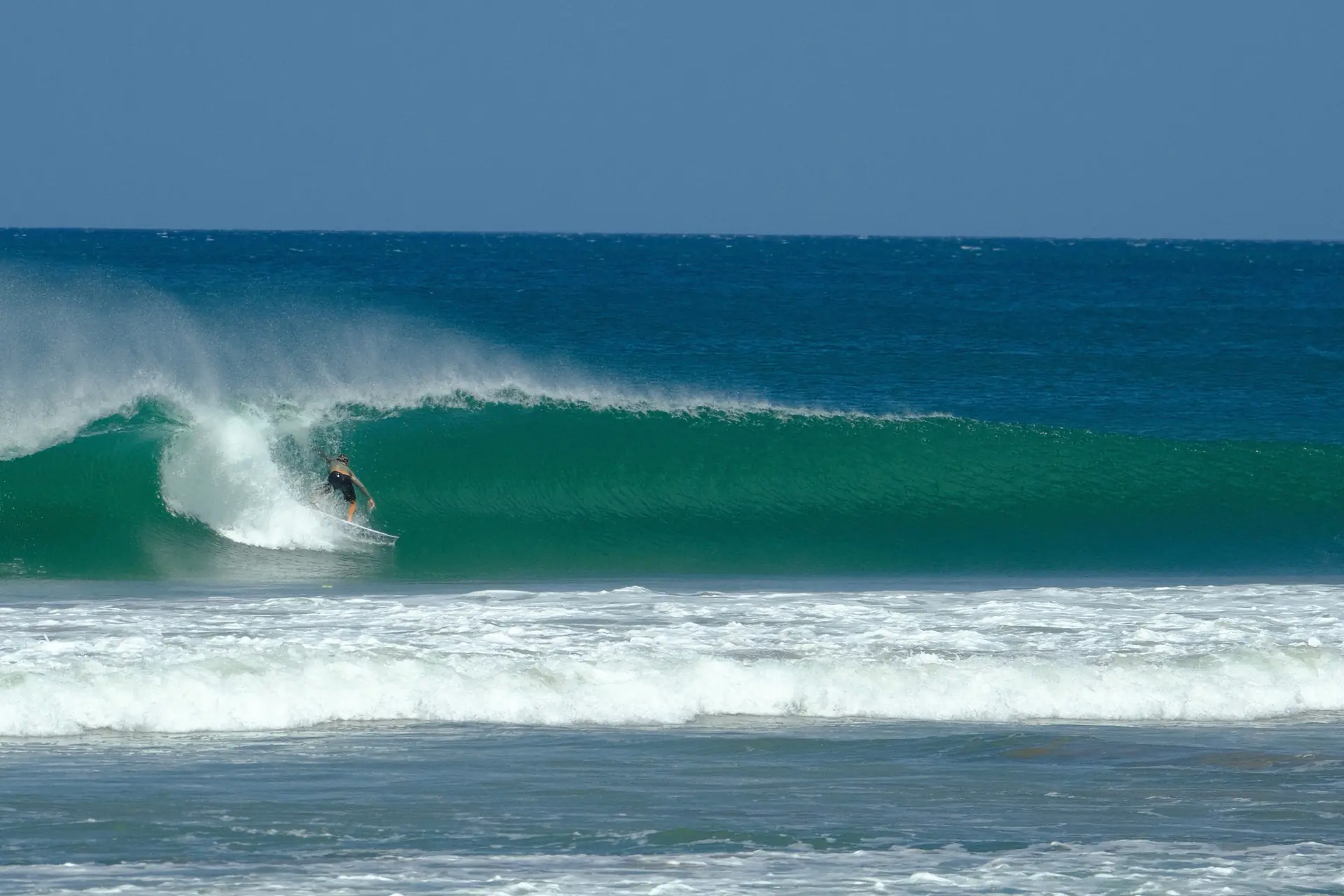 Surfer riding inside a barrel at Playa Colorado, Nicaragua