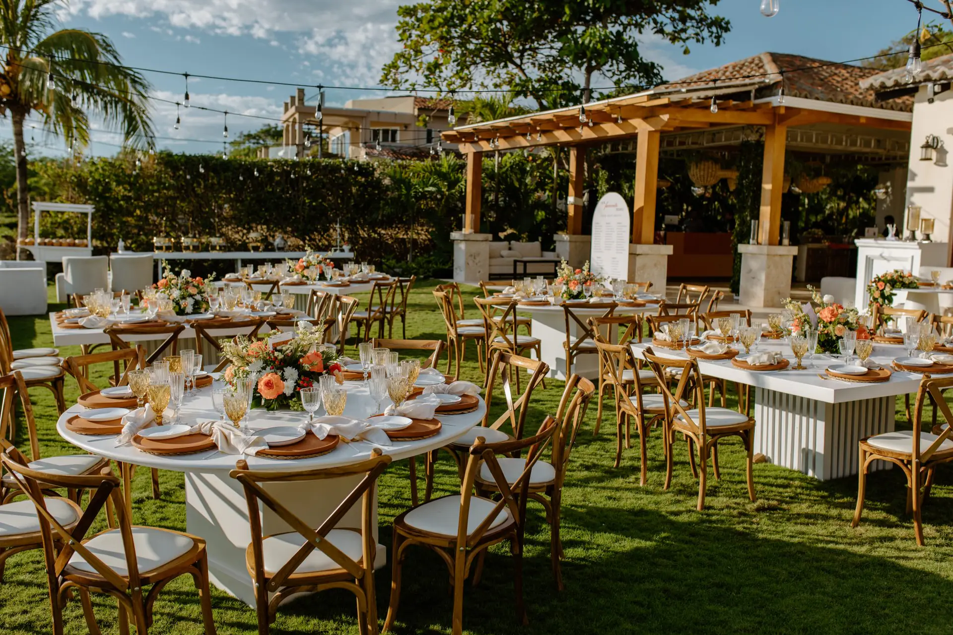 Wedding reception set across the oceanfront lawn at Casa Colorados